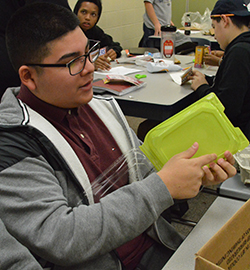Ernie Peredo-Briceno prepares materials for his project