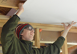 Senior Corbin Butterly hoists up the drywall