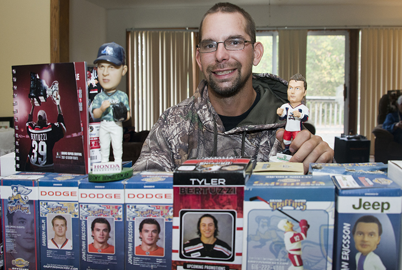 Alanowski with his bobblehead sports collection; his favorite is hockey