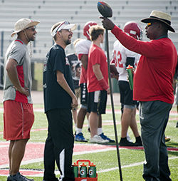 Alanowski chats it up with coaches Dion Charity, left, and James Stokes