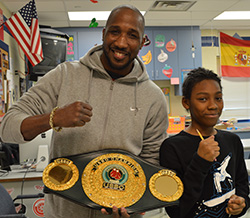 Professional boxer and entrepreneur Parnell Gates shows his belt to sixth-grader Quijuan Madion-Lewis