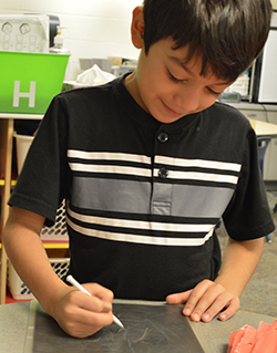 Isaac Garcia practices writing