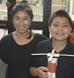 Jose Escobedo proudly shows off his “helicopter chair” with fifth-grade teacher Sung Pak