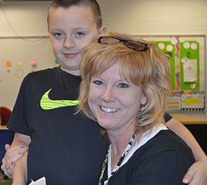 Not many days go by without a hug from Mrs. Slentz for second-grader Reid Glupker