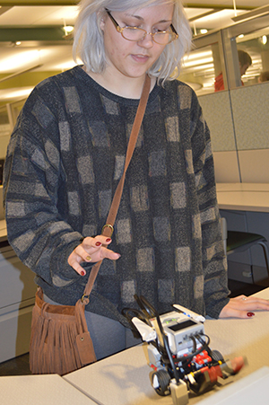 Tech Center student Elaine Weider works with a mini robot in information technologies