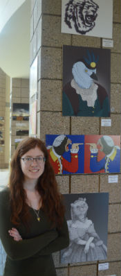 Marissa stands near her collection of art displayed in the high school’s hallway