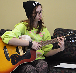 Senior Marissa Minier practices playing the guitar