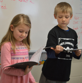 Students read different parts in the play