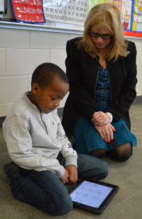 A teacher works on reading with a student