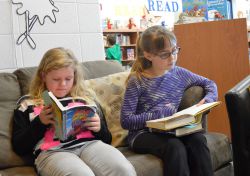 Maris Guppy (left) and Gracie Huizing burrow into books they selected