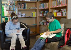 Sierra Stoy (left) and Richard Toris have fun telling each other about their books