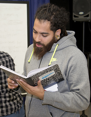 Marcel Price reads student work at a spoken-word poetry workshop run by a group of teaching artists called The Diatribe