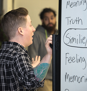 The Diatribe’s Rachel Gleason writes poetry ideas on the board, which students learned in the workshop at Valleywood Middle School