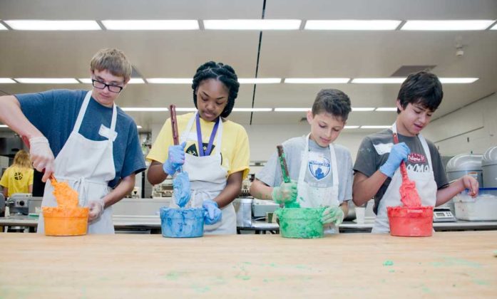 Matt Kroll, ninth grade, Talmadge homeschooler; Dasani Rosser, ninth grade, Wyoming Junior High; Zev Deaner, seventh grade, EGR Middle; and Nate Gil, eighth grade, FH Eastern Middle; make frosting